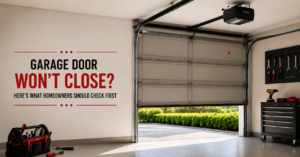Homeowner checking garage door safety sensor after door won't close